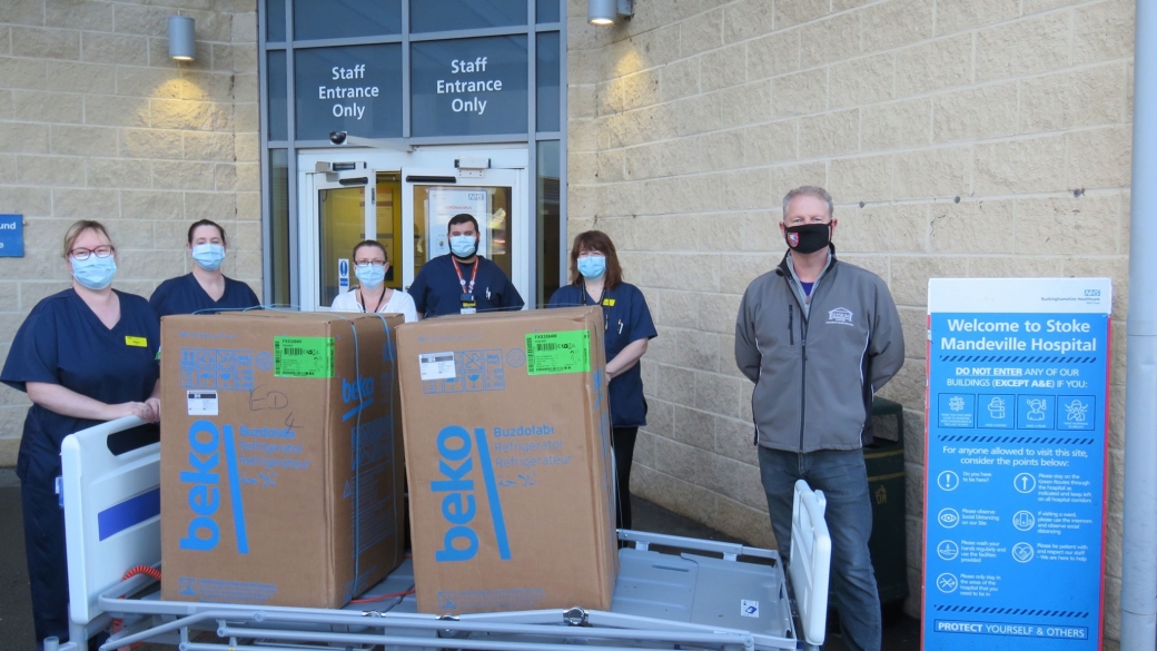 People wearing face masks with 2 boxed freesers